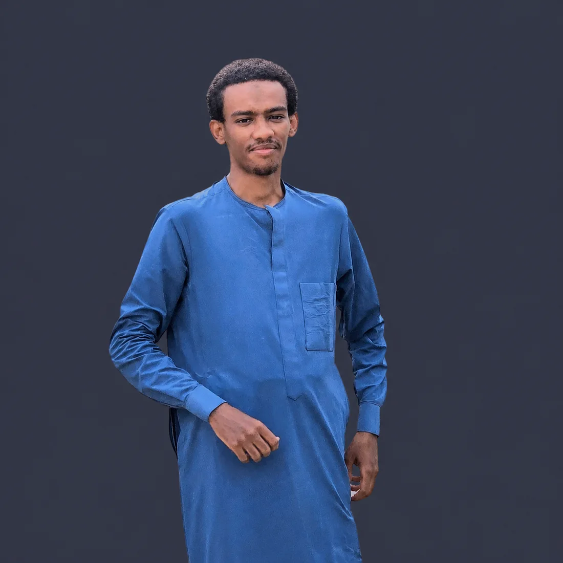 Portrait of Amdjad Aboubakar wearing a blue traditional garment